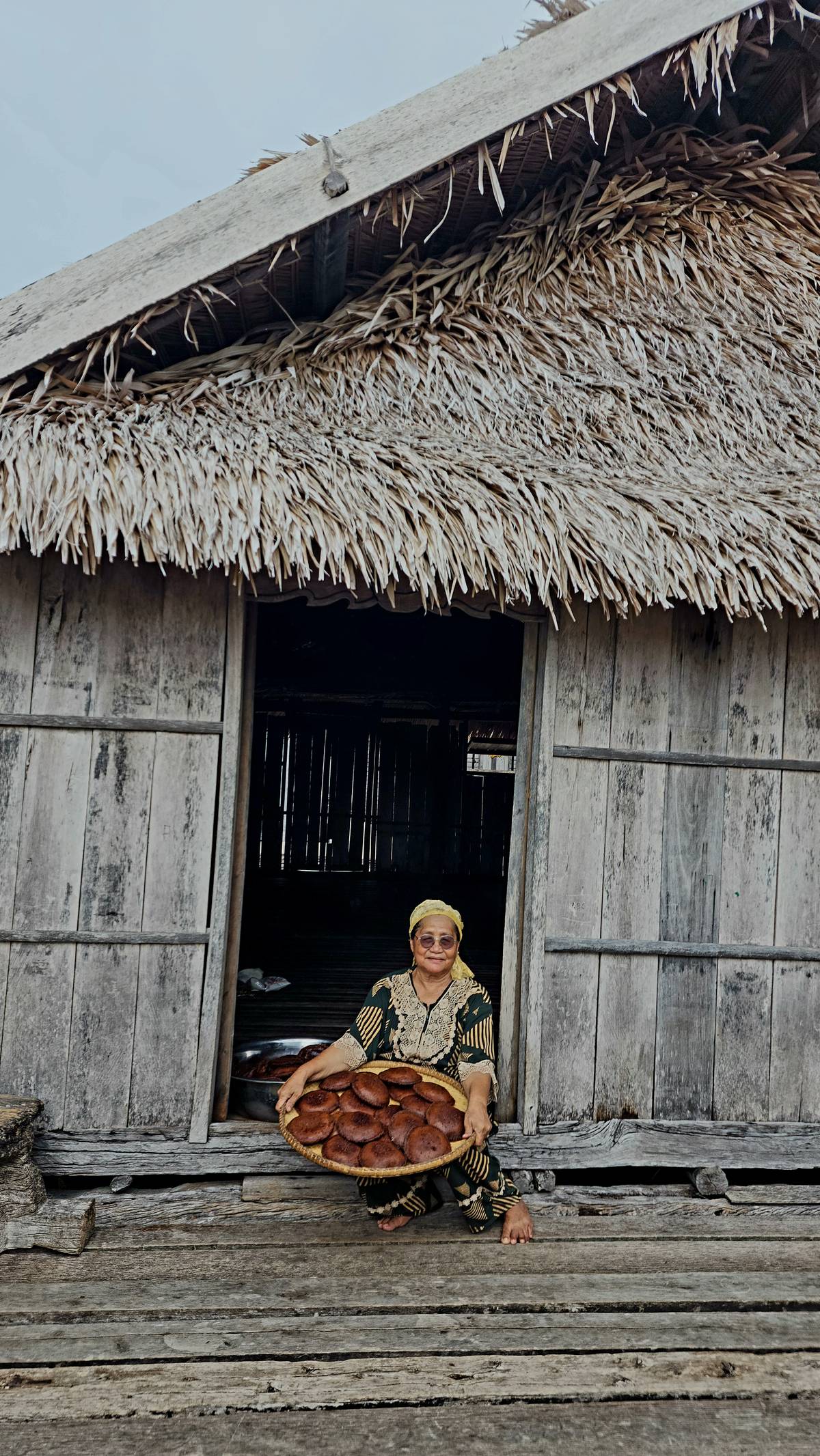 Jannatun Jahuran, holding a tray of panyam she just made for Pagkamboan tomorrow.